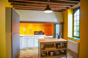 a kitchen with yellow and white cabinets and a table at Crazy Villa Gouadiere 45 - Heated pool - Basket - 1h45 from Paris - 30p in Poilly-lez-Gien