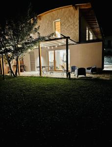 a house with chairs in a yard at night at villa amarena, centralissima giardino e parcheggio in Angera