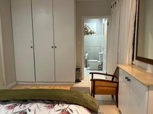a bedroom with a bed and a bathroom at Apartment Downstairs Sedgefield in Sedgefield