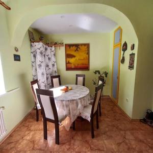 a dining room with a white table and chairs at Quite House in Liepāja