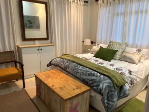 a bedroom with a bed with a table and a mirror at Apartment Downstairs Sedgefield in Sedgefield