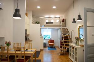 a room with a dining table and a loft bed at Jane's Place in Ljubljana