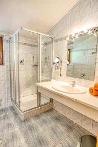 a bathroom with a sink and a shower at Appartments Geisler in Achenkirch
