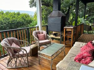 a porch with chairs and a couch and a stove at Apartment Downstairs Sedgefield in Sedgefield