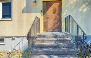 a set of stairs leading to a wooden door at 2 Bedroom Amazing Apartment In Visby in Visby +8 photos