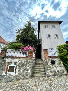 a white building with a staircase leading up to it at Sv. Hubertus in Český Krumlov