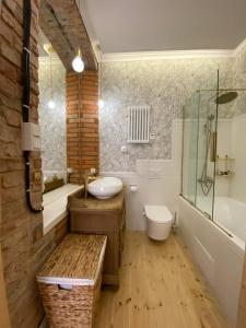 a bathroom with a tub and a sink and a shower at Apartments PSD - Anny Łajming 1A in Słupsk