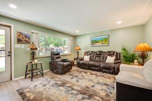 a living room with leather furniture and windows at Pet-Friendly Gem with Private Yard in Westminster! in Westminster