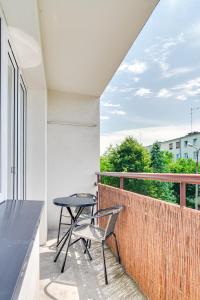 a patio with a table and a chair on a balcony at Apartament Słoneczny in Kędzierzyn-Koźle