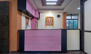a room with a purple counter with a painting on the wall at Treebo Eden Park Hotel, 3 Km From Puducherry Airport in Puducherry