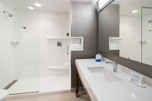 a bathroom with a sink and a shower at Courtyard by Marriott Hilton Head Island in Hilton Head Island