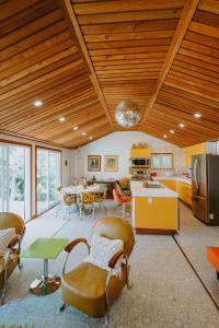 a kitchen and dining room with a wooden ceiling at 1970s retro vibe - The Creamsicle - Lake Huron Oliphant in Wiarton