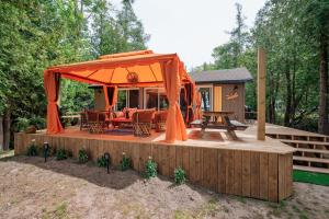 a gazebo with a table and chairs on a deck at 1970s retro vibe - The Creamsicle - Lake Huron Oliphant in Wiarton