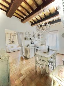 a kitchen with a table and a dining room at Spello House Altana in Spello