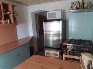 a kitchen with a stainless steel refrigerator and a stove at Ferienzimmer Muns in Annaberg-Buchholz
