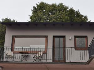 a balcony of a house with two chairs on it at Ferienwohnung Waldbröl in Waldbröl