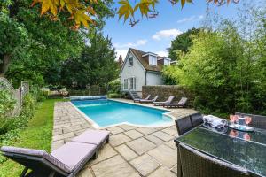 a swimming pool in the backyard of a home at The Poolhouse by Inspire Stays in Petworth