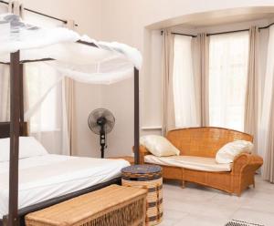 a bedroom with a bunk bed and a chair at Paphiri House in Zomba