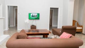 a living room with a couch and a table at Paphiri House in Zomba