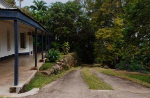 a dirt road in front of a house at Paphiri House in Zomba