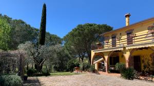 豐特博蘭達的住宿－Affittacamere La Crognoleta，一座大黄色房子,后面有树木