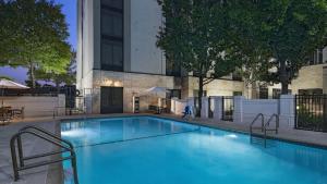 a large blue swimming pool in front of a building at Hyatt Place Austin Arboretum Domain Area in Austin