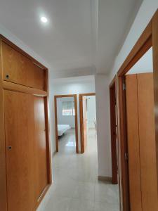 a hallway with wooden cabinets and a bedroom at Atenas 2 - Monty´s in Jávea