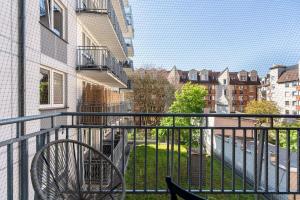a balcony with a bike sitting on a railing at Kosińskiego Apartament Poznań by Noclegi Renters in Poznań