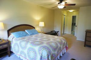 a bedroom with a large bed and a ceiling fan at Kona Pacific C319 in Kailua-Kona +12 photos