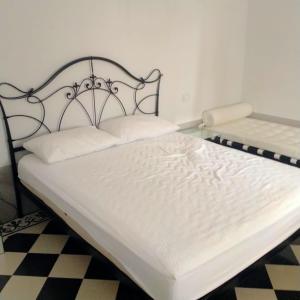 a white bed with a metal headboard in a room at Hotel & Resort Lunatenuta in Mondragone +69 photos