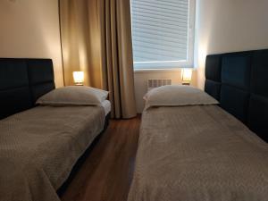 Postel nebo postele na pokoji v ubytování Apartmany Rubin Nesvady