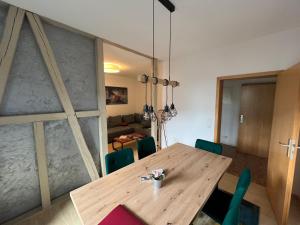 a dining room with a wooden table and chairs at Apartment Napoleon, Nähe Zentrum, 2 Schlafzimmer, großer Balkon, free Wifi ,Parken in Jena