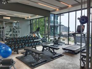 a gym with a lot of exercise equipment and windows at B303-Nice Seaview 1 Bedroom 300 meters walking To Ao Nang Beach in Ao Nang Beach