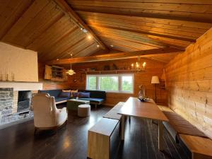 a living room with a couch and a table at Baybu - cabin close Geilo Skisenter and the center of Geilo in Geilo