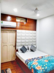 a small bedroom with a bed in a boat at Hotel Florence in Siliguri