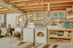 a laundry room with a washing machine and a desk at Alexandria Cabin with Patio, Grill and Deck 