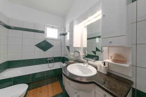 a bathroom with a sink and a toilet and a tub at Villa Melenia 2 in Agia Pelagia