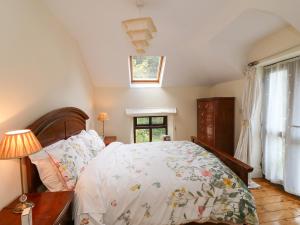 a bedroom with a large bed and a window at Toberlonagh 