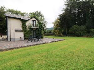 a house with a patio and a grass yard at Toberlonagh 