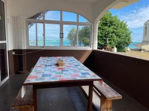 een tafel in een kamer met een raam bij Villa de la Playa in Blue Bay