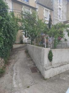 an alley in front of a building with a fence at Studio rénové avec goût in Poitiers