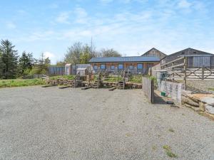a farm with wooden fences and a building at Daisy Bank Camp in Hebden Bridge +16 photos