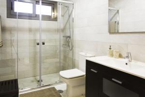 a bathroom with a shower and a toilet and a sink at Apartamentos Borizu Playa in Barro de Llanes +44 photos