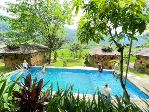 a group of people sitting around a swimming pool at Sapa Bamboo Eco in Sa Pa
