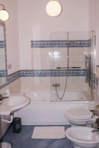 a bathroom with a tub and a toilet and a sink at Casa Maria Al Campo in Salerno
