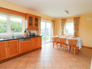 a kitchen with a table and a dining room at 29 Church Field in Doonbeg