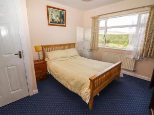 a bedroom with a large bed and a window at Forest View 