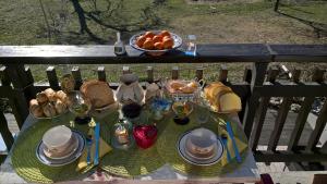 a table with a plate of food and a bowl of fruit at CHALET HARMONIE in Auris