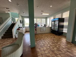a living room with two chairs and a television at HillView Inn at Six Flags Fiesta in San Antonio
