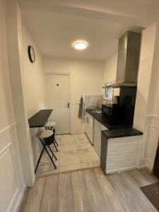 a kitchen with a sink and a counter top at Appartement Cosy in Le Bourget